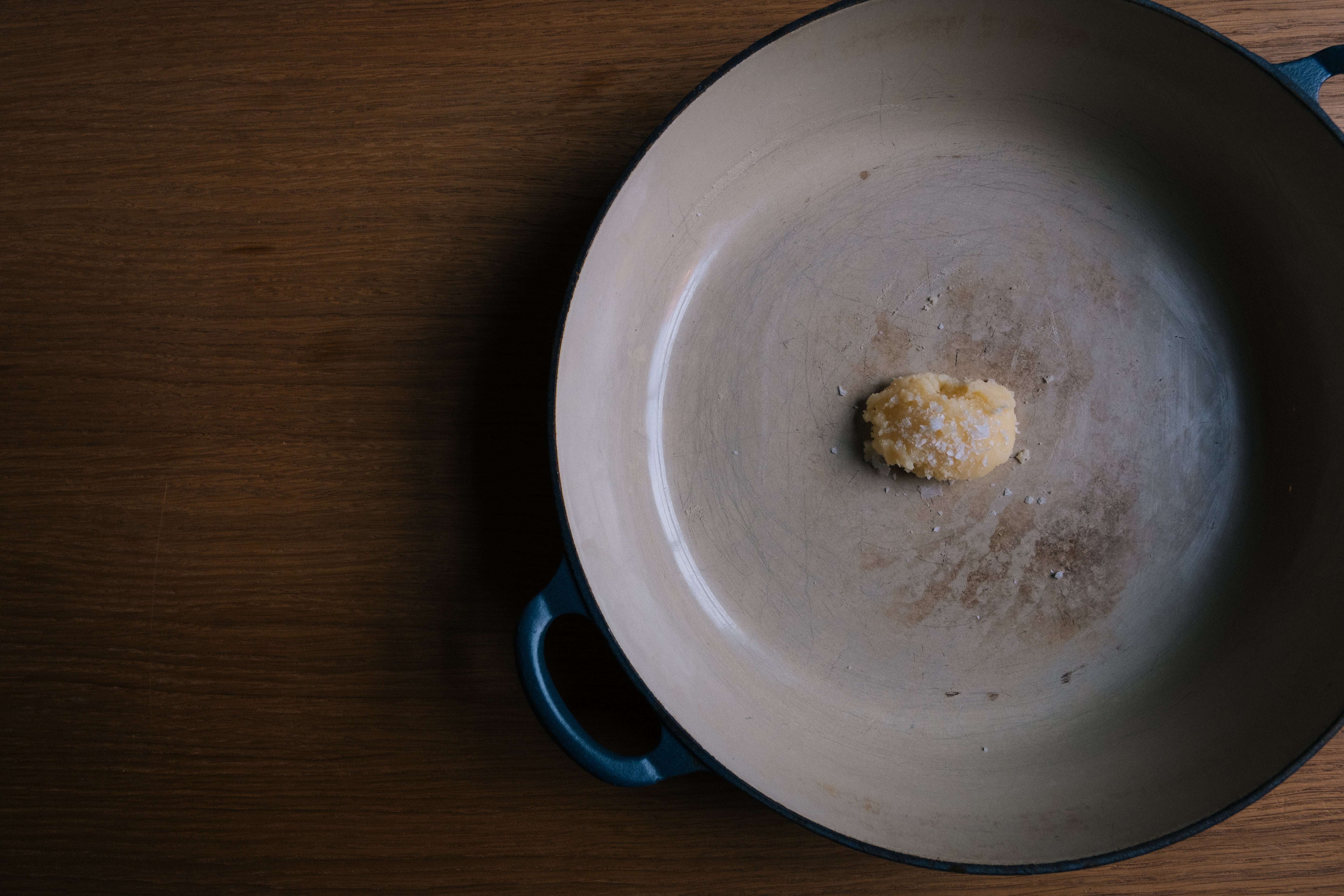 Spoonful of Sublime's Better Roasting Fat in a casserole dish, topped with flaked salt