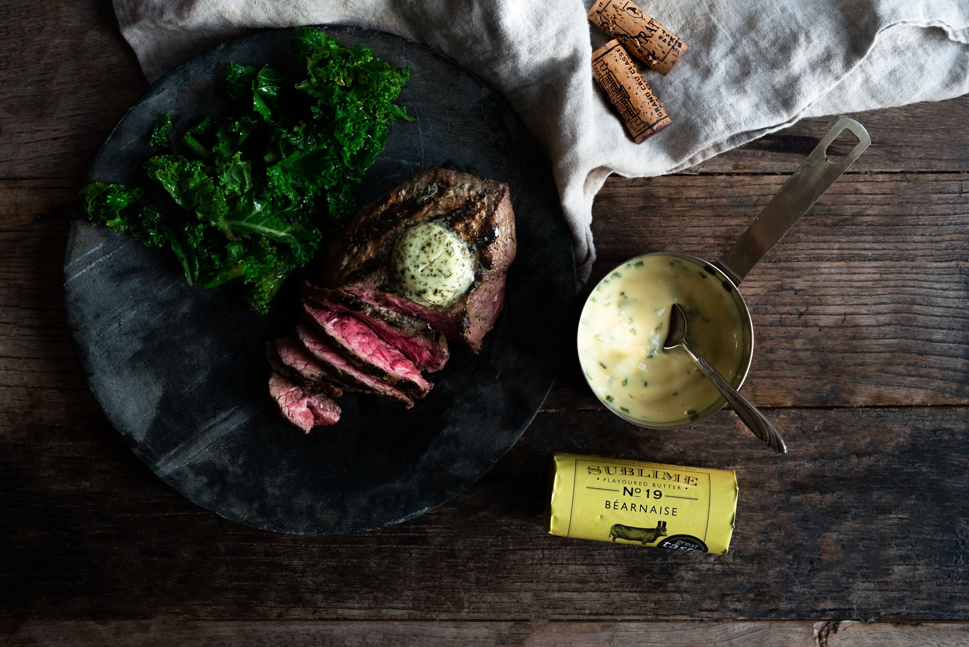 A steak, cooked rare, served with kale, béarnaise sauce and Sublime's béarnaise butter